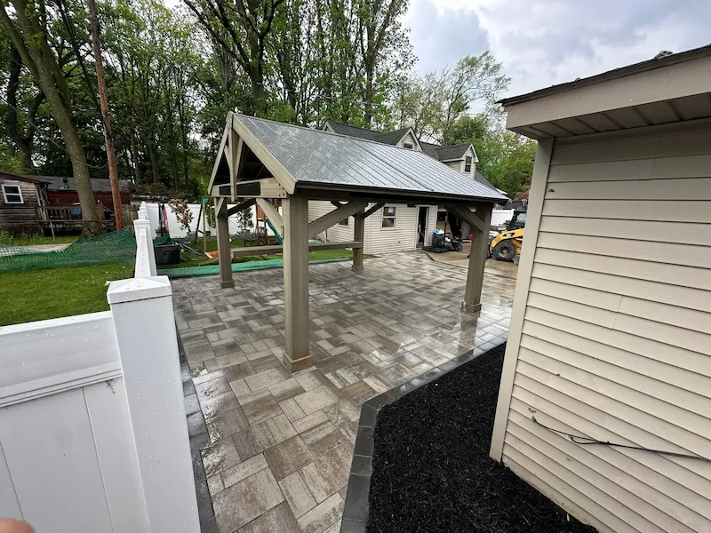Finished timber pavilion with a metal roof and paver floor