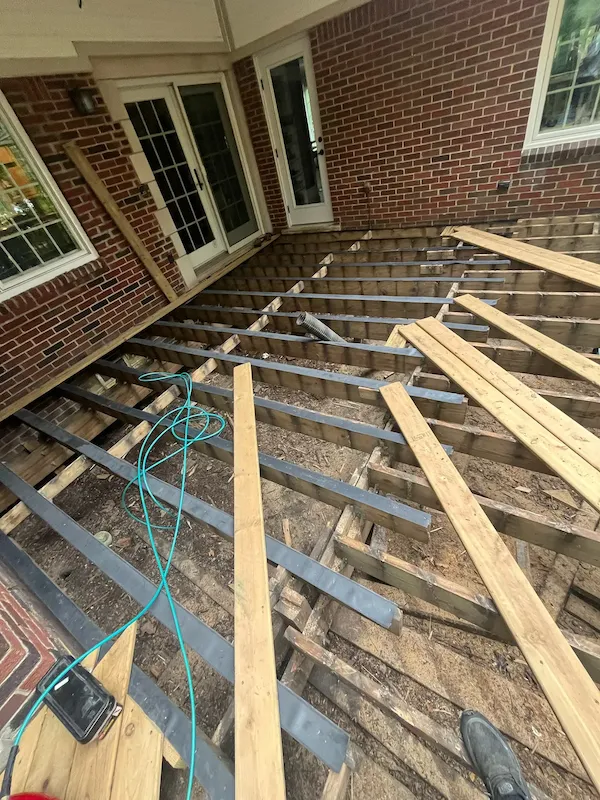 Exposed deck framing and joists during a deck rehabilitation project