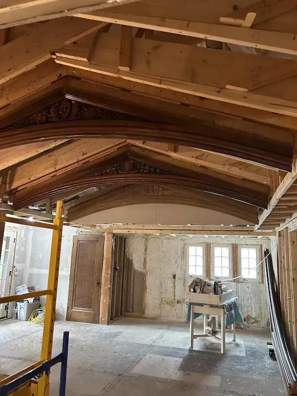 Exposed ceiling and wall framing inside a remodeled home